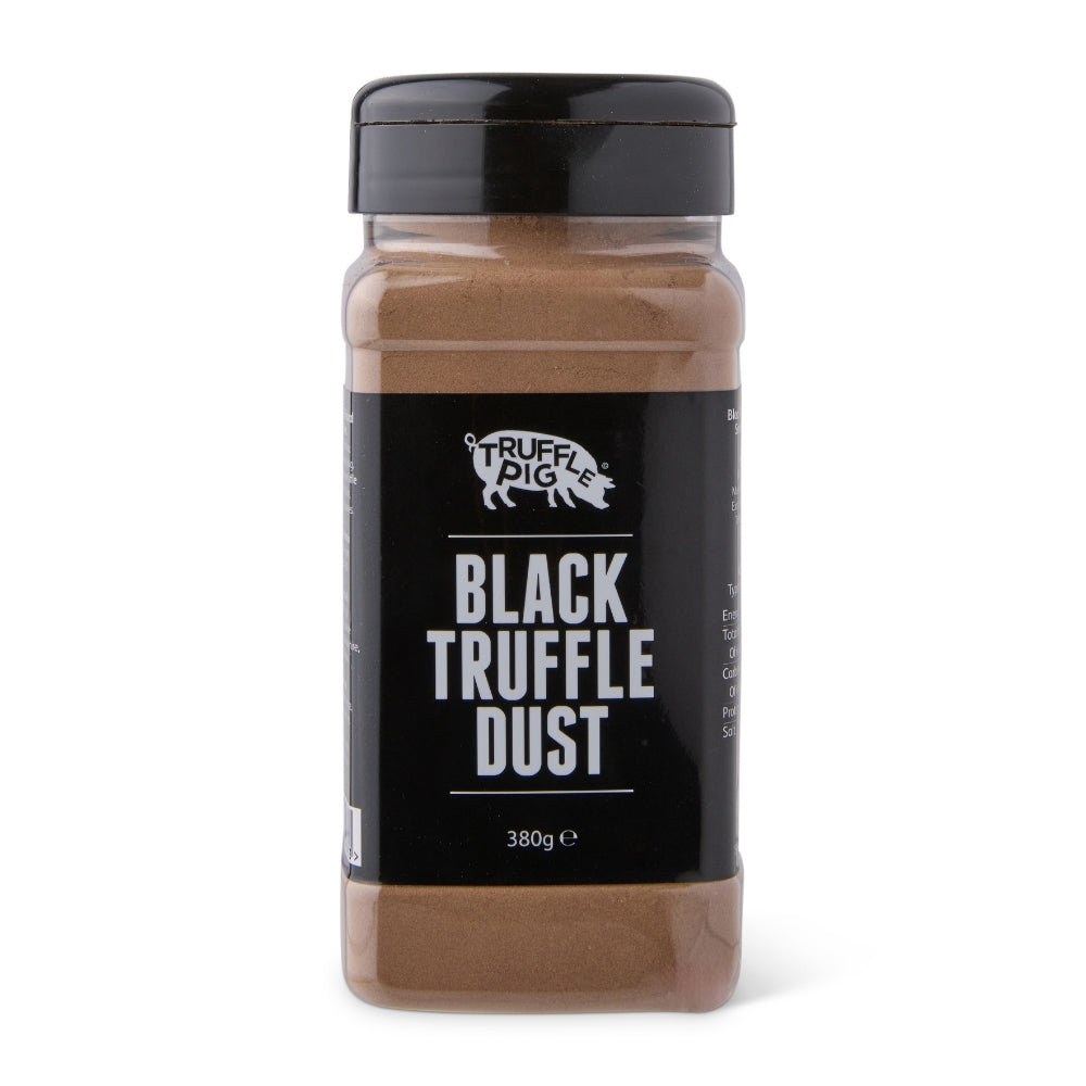A clear plastic spice jar of Truffle Pig Black Truffle Dust with a black lid and black label, set against a plain white background.
