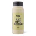 A bottle of Truffle Pig Black Truffle Mayonnaise on a clean white background. The clear bottle shows the mayonnaise inside, with a prominent label and a black cap.