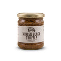 A glass jar of Truffle Pig's Minced Black Truffle 180g with a gold lid and a beige label, set against a plain white background.