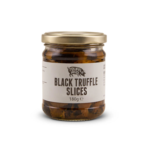 A glass jar of Truffle Pig's Black Truffle slices 180g with a gold lid and a beige label, set against a plain white background.